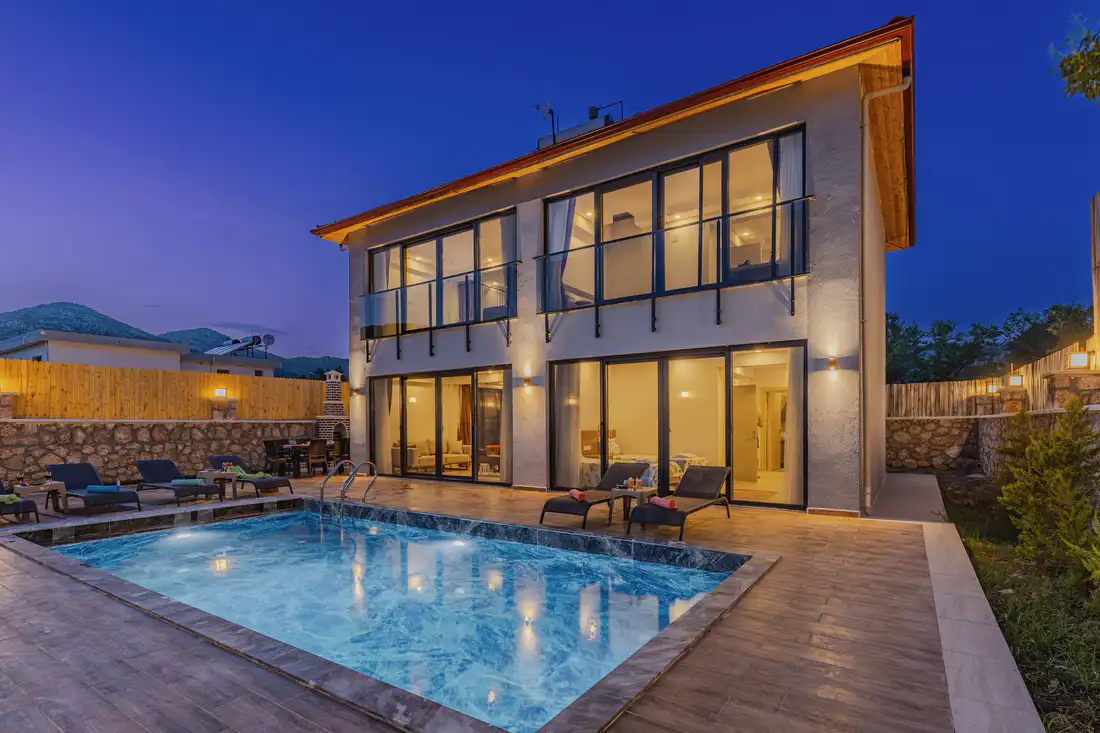 A pool and terrace at dusk